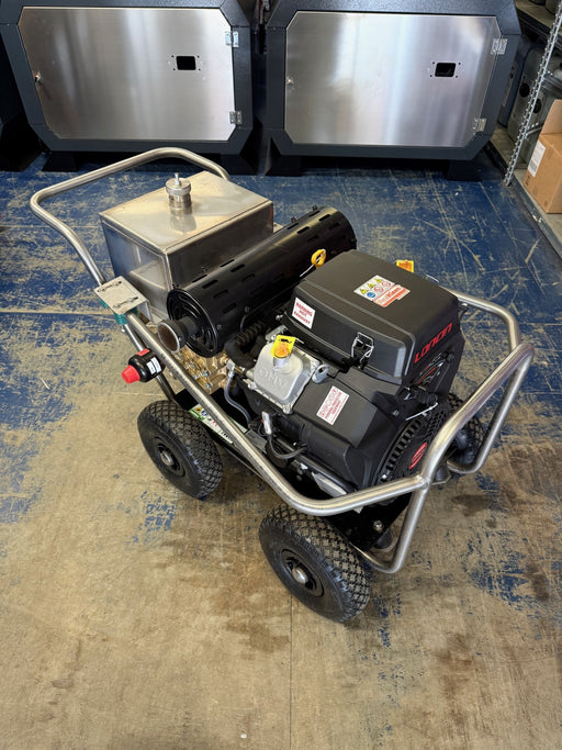 A mobile petrol pressure washer with black and gray colors, mounted on a trolley with large wheels, including a high-pressure hose and a lance.